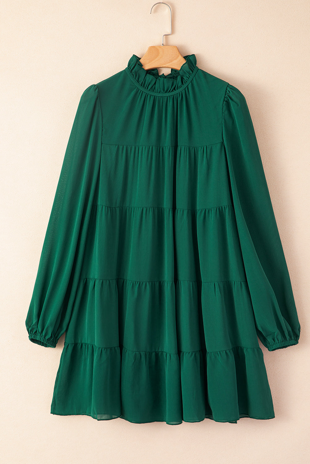 Green dress with ruffles and puffed sleeves, high neck, bow in the back