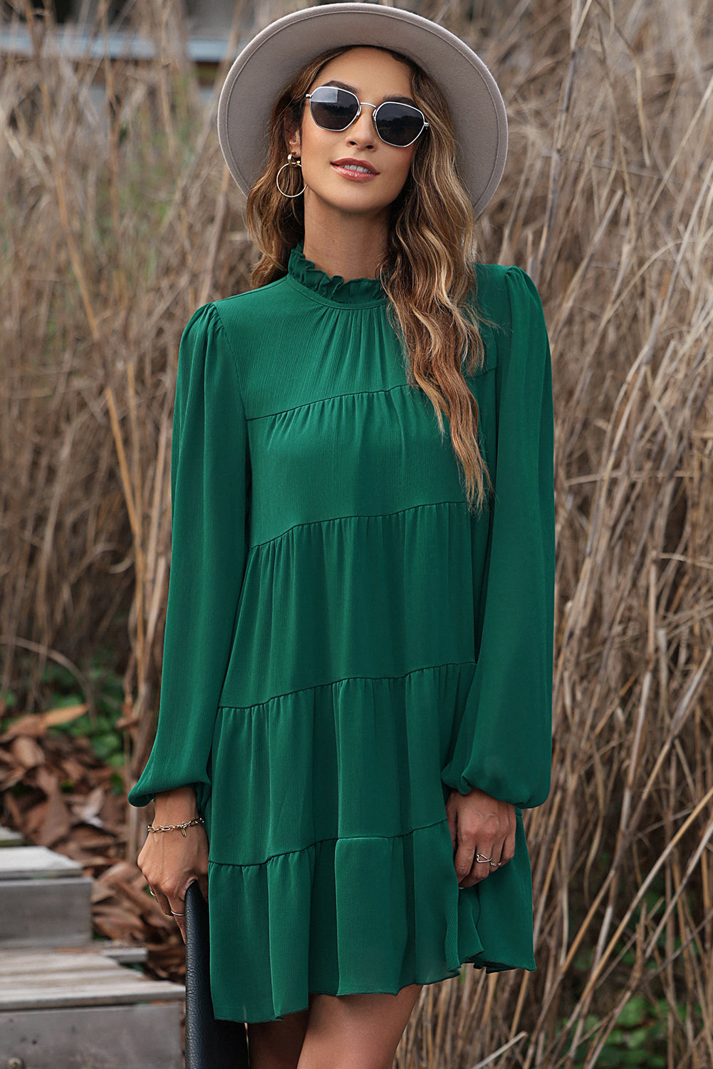 Green dress with ruffles and puffed sleeves, high neck, bow in the back