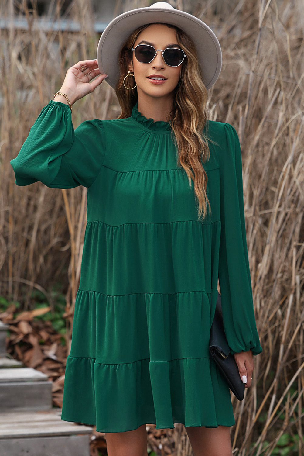 Green dress with ruffles and puffed sleeves, high neck, bow in the back